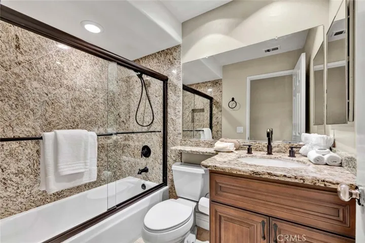 Beautifully remodeled guest bathroom featuring modern finishes and updated fixtures.
