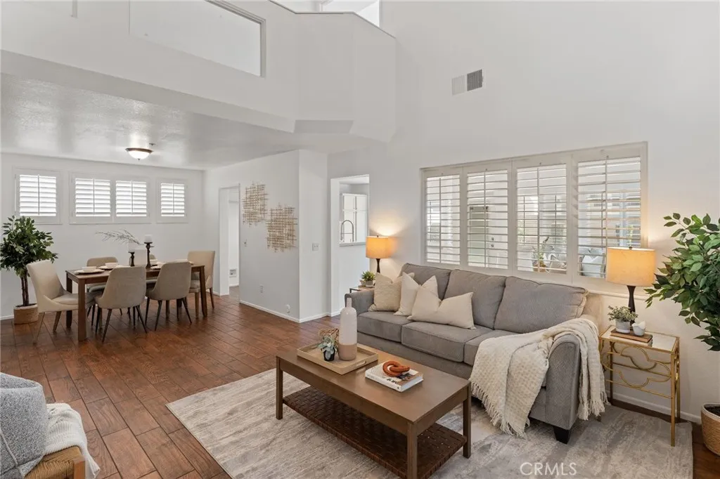 Living Room open to Dining area with lots of Natural Lighting & high Ceilings