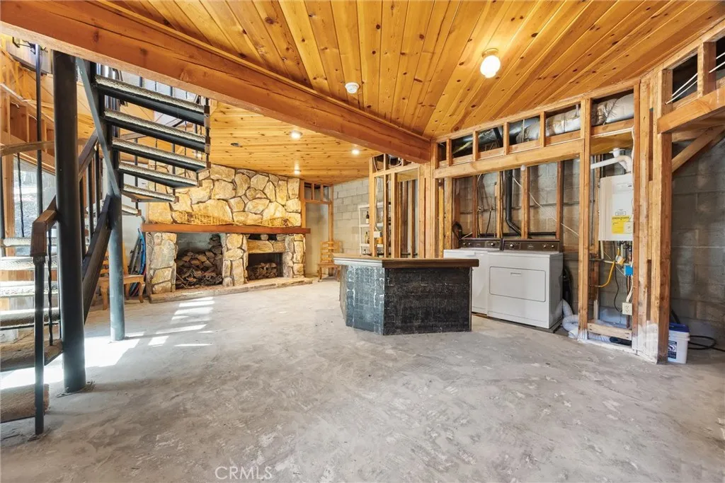 Unfinished basement with beautiful wood ceilings and second fireplace. Washer/dryer included.  New tankless water heater.
