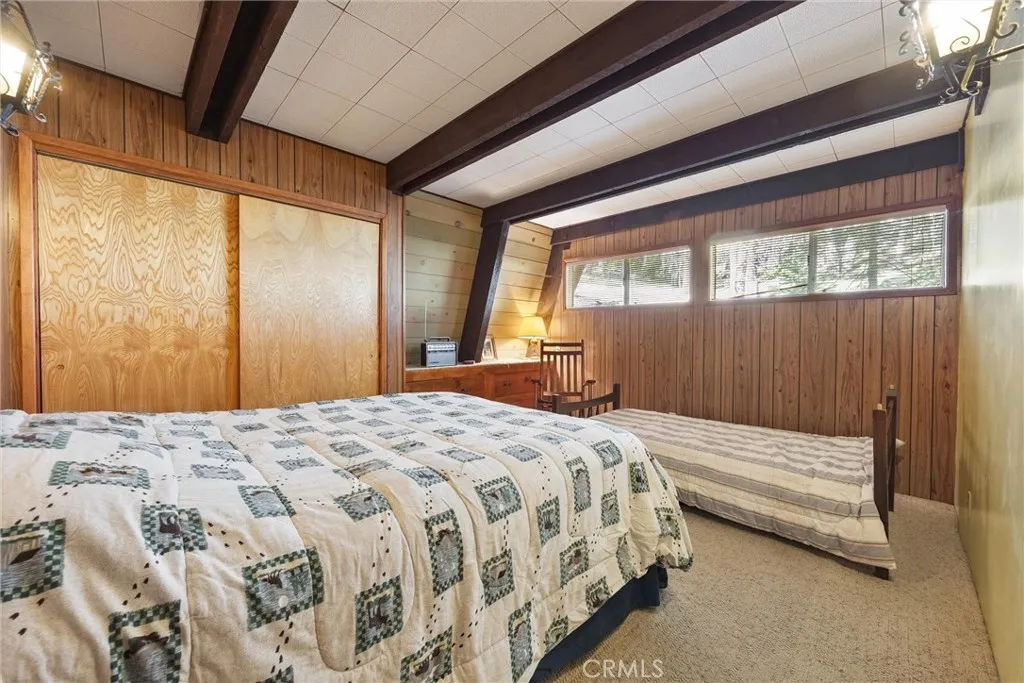 Bedroom #1 downstairs with large closet and built-in drawers for storage, with ensuite bathroom