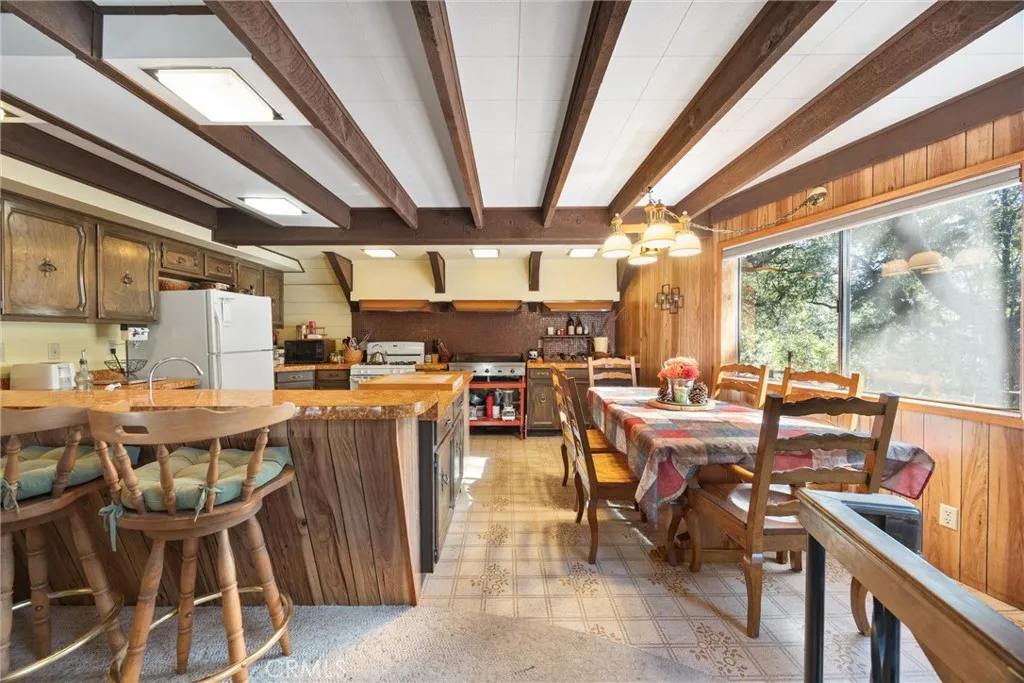 Facing Bar, dining, and kitchen