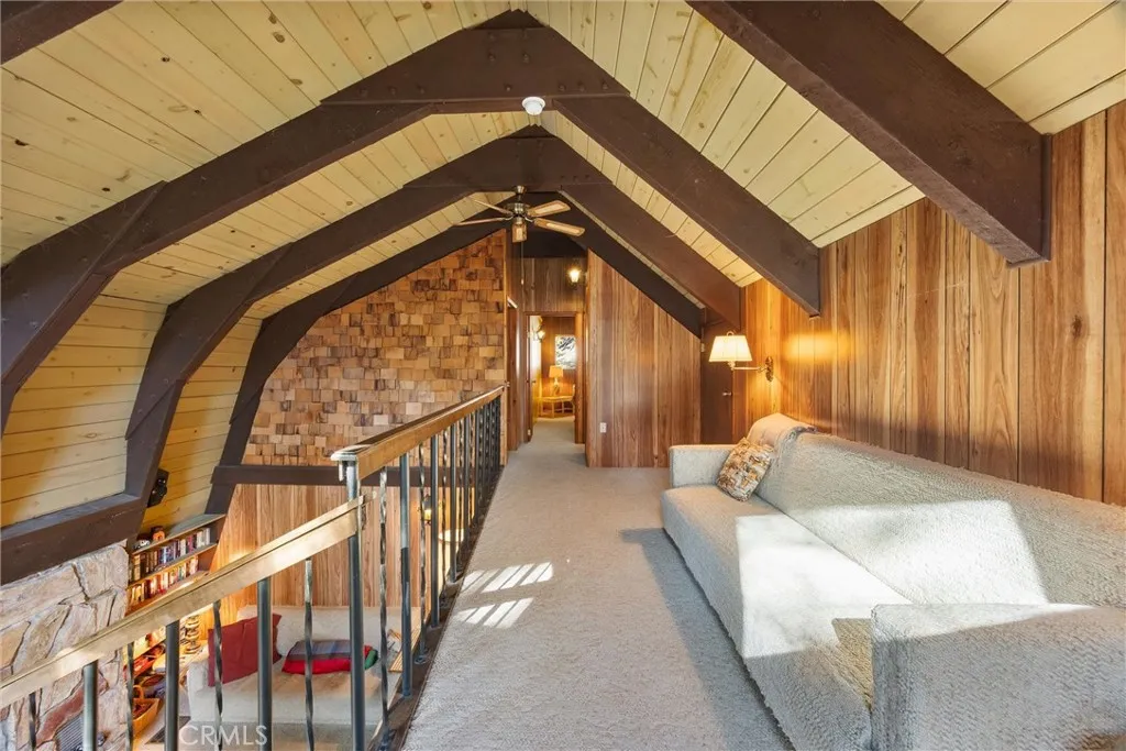 View of loft with living room below.  Beautiful wood ceilings and beams