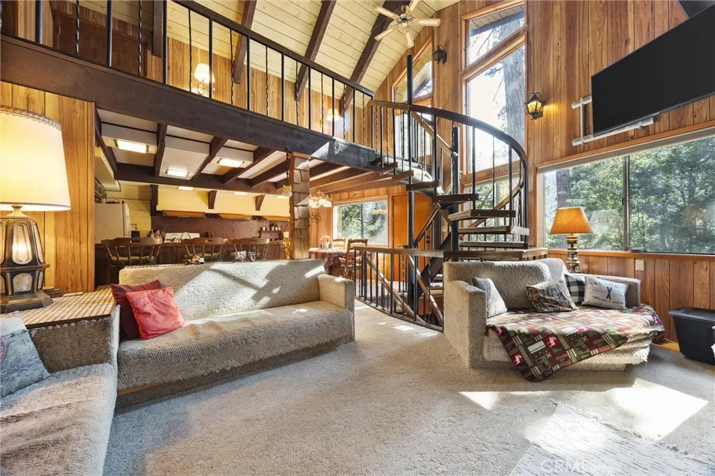Facing kitchen and dining from living room.  View of loft above.