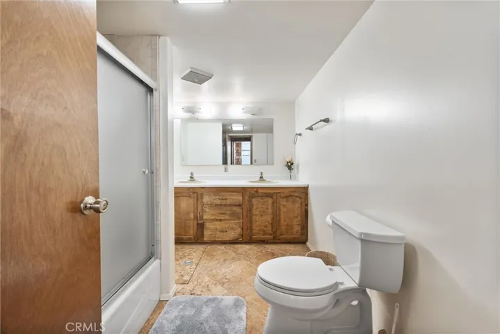 Extra large bathroom with dual sinks and tiled shower.  Newly renovated.