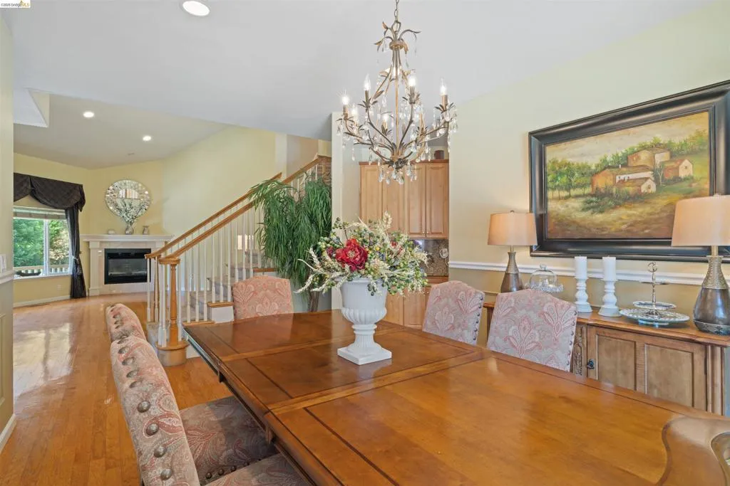 Dining area featuring a vaulted ceiling and wood-finish flooring