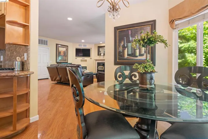 Dining area featuring a glass-top table, decorative chairs, and a chandelier