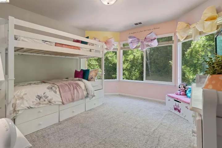 Room with an abundance of natural light featuring an expansive bay window