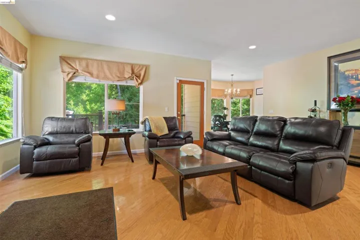 Light wood-finish flooring complements the neutral wall color in this living area