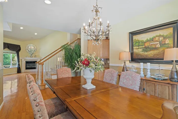 Dining area featuring a vaulted ceiling and wood-finish flooring