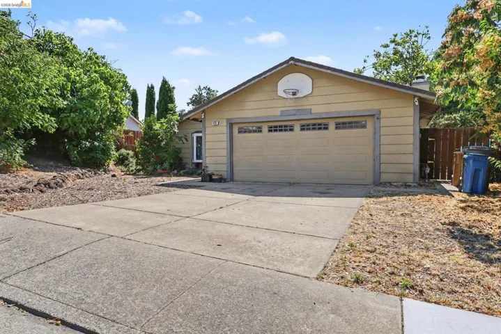 Single-story residence featuring a two-car garage with panel windows