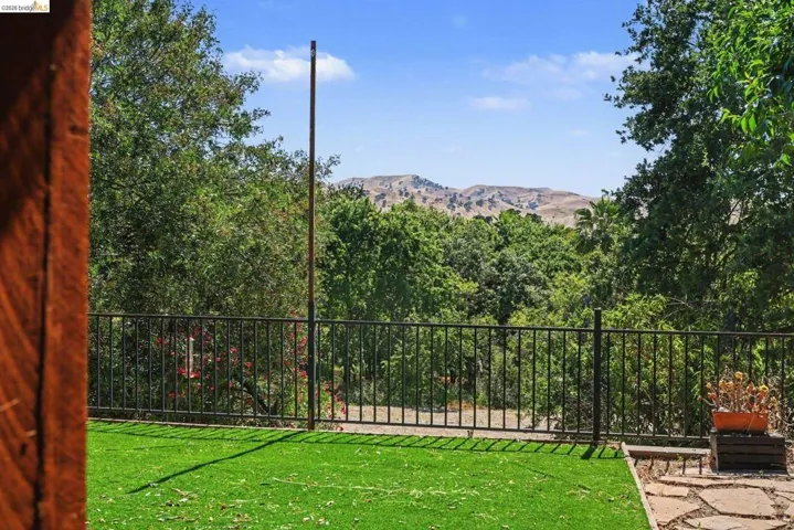 Expansive outdoor area featuring artificial turf and flagstone accents