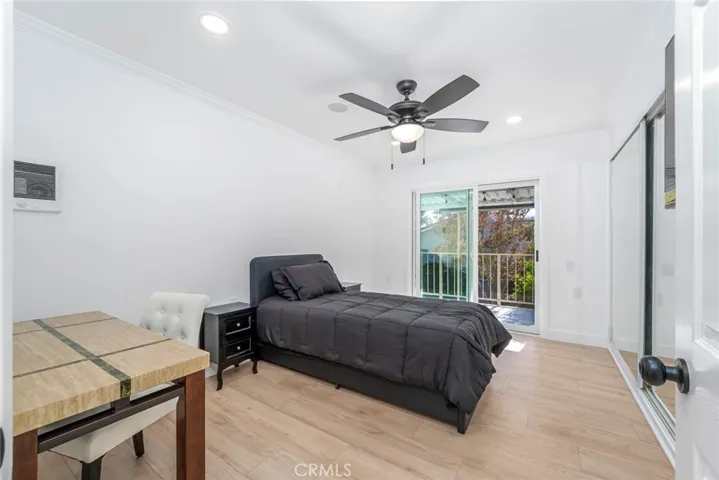 Guest room with access to balcony through dual pane sliding doors