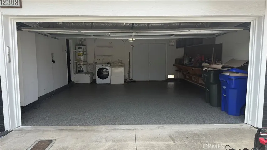 Two car garage, convenient laundry area and work bench