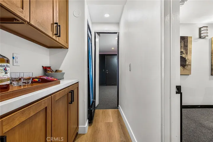 the hallway to the theater has a large fridge to hold your drinks and cabinet/counter to hold your snacks