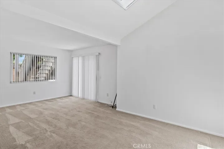 Family room off of dining area, featuring large skylight