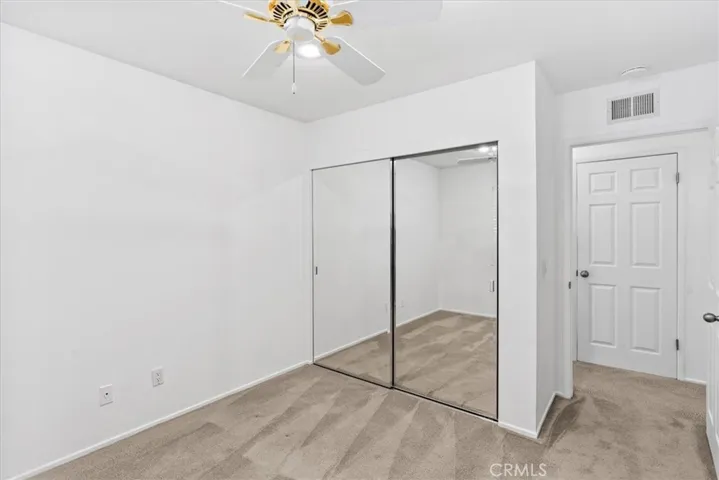 Guest Bedroom one different view featuring sliding mirror closet doors