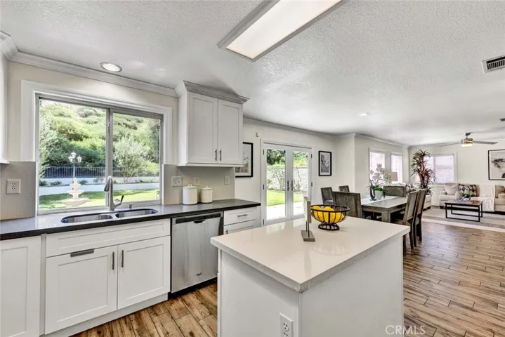 Kitchen facing back yard followed by dining area and family room