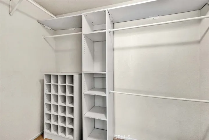 Main bedroom walk in closet with build ins