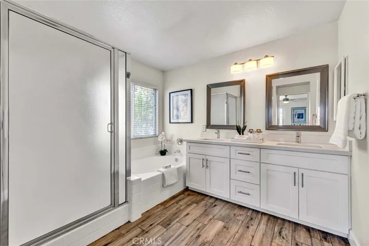 Main bedroom bath with separate bath tub and separate shower plus double sinks