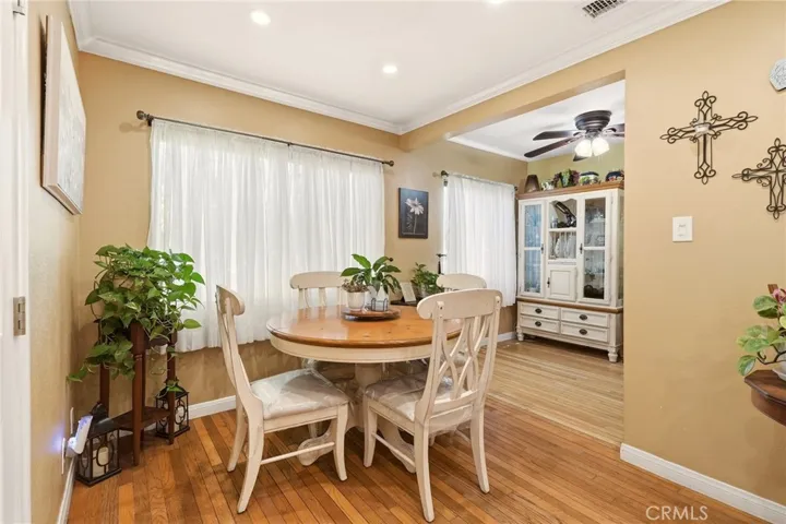 The dining area flows into a separate breakfast area, creating a functional layout with convenient access to the kitchen.