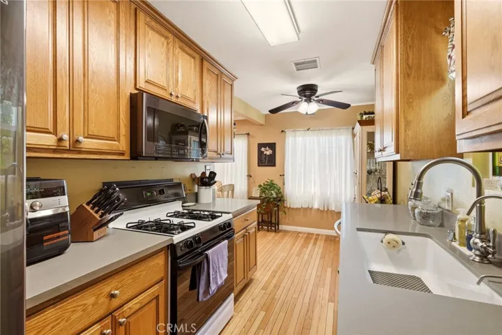 The updated kitchen features a large sink and is adjacent the breakfast area.