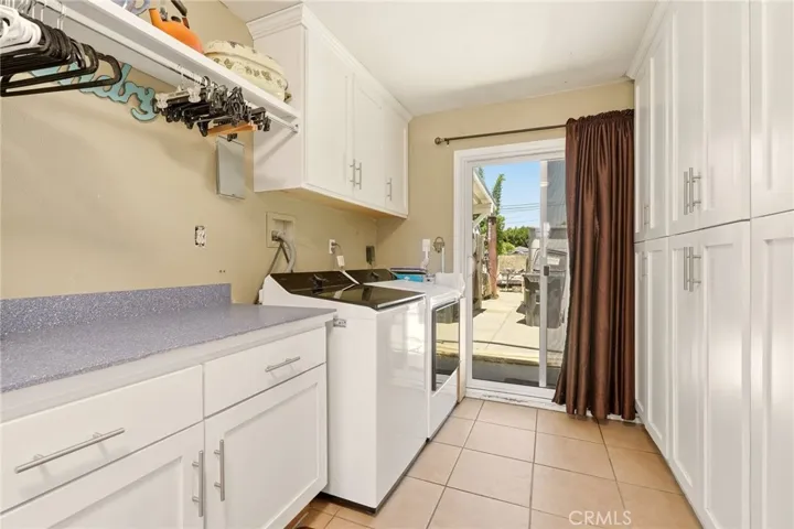 Spacious laundry room with abundant storage cabinetry.