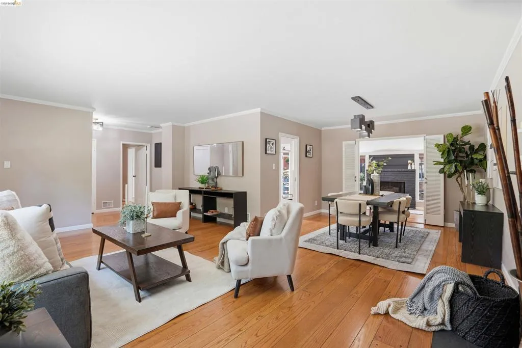 Hardwood flooring extends throughout this open-concept living and dining area
