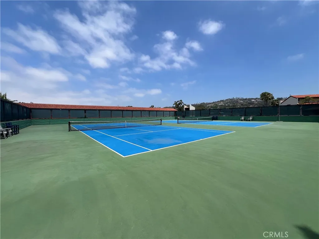 Tennis courts. AI enhanced blue sky.