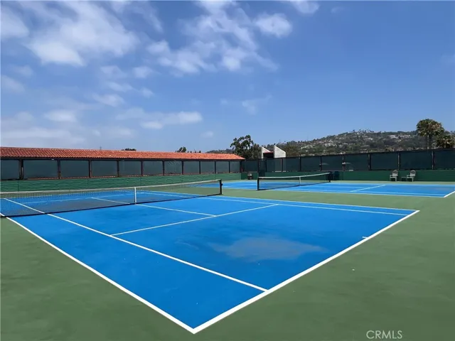Tennis courts. AI enhanced blue sky.
