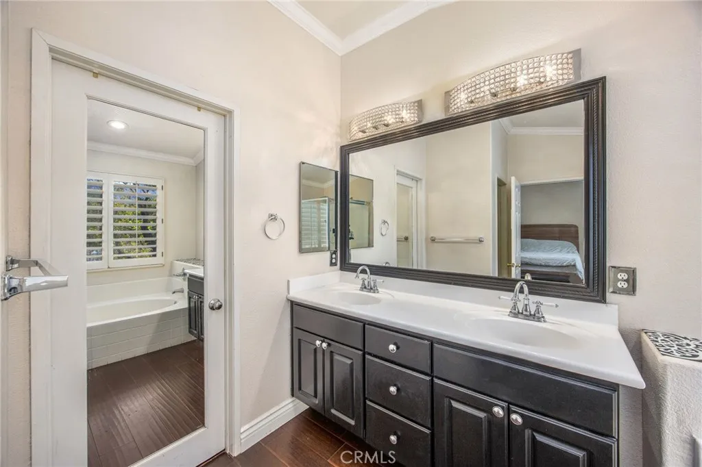 Dual sinks and extensive cabinetry add convenience to the primary bathroom