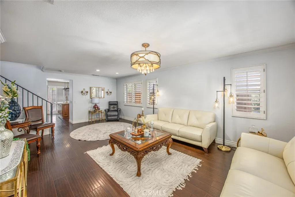 A bright formal living room greets you upon entry and flows seamlessly into the home's main living areas