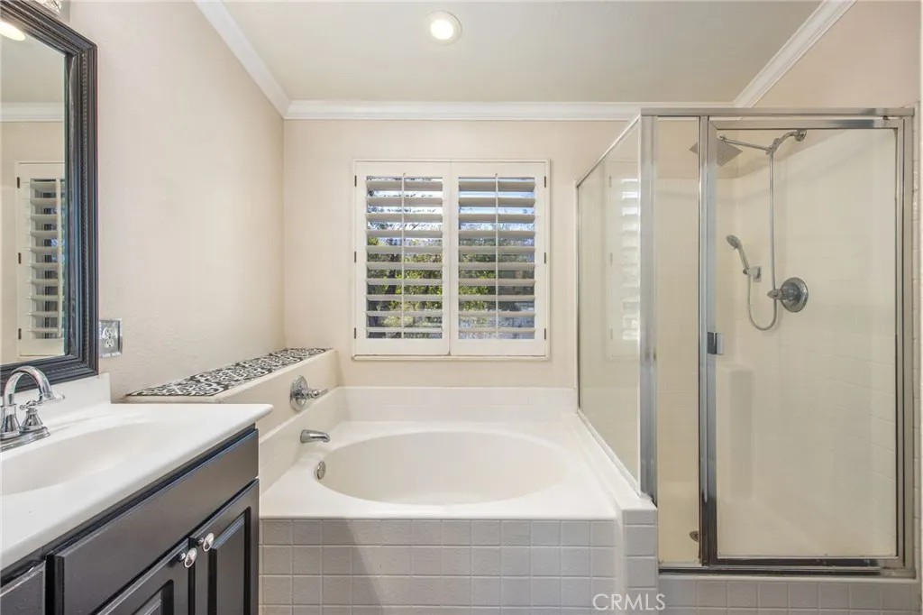 The spacious primary bath includes a separate shower and soaking tub