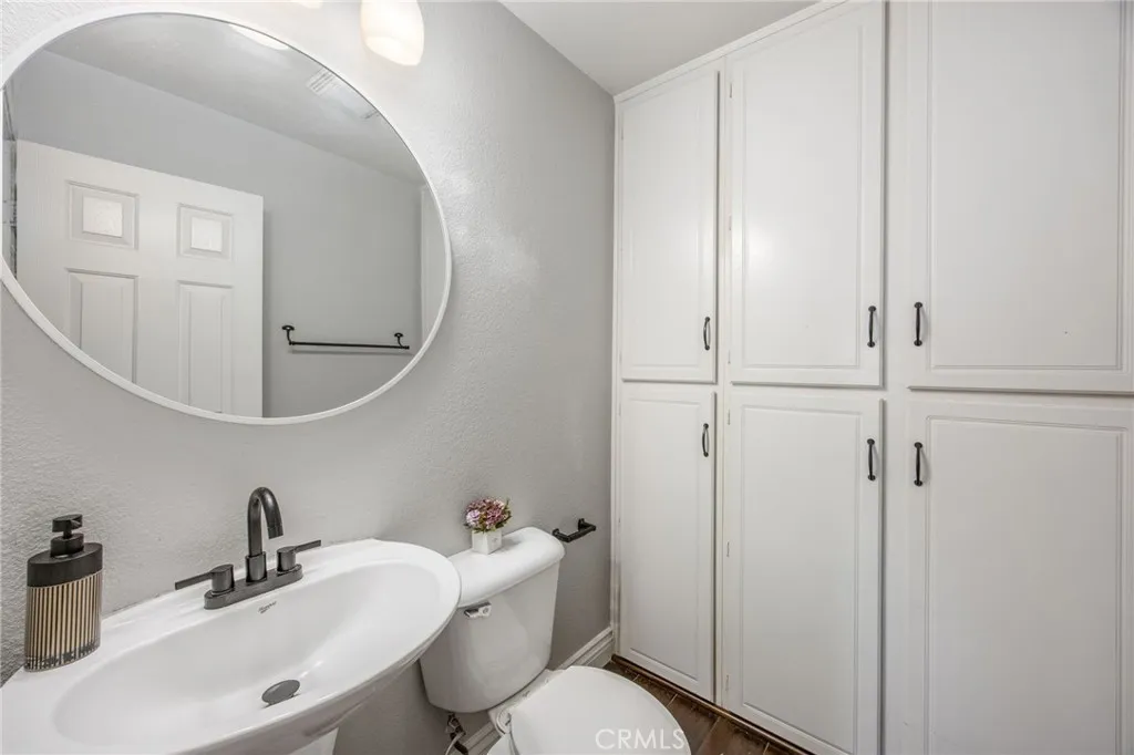 Built-in cabinetry adds valuable storage rarely found in a powder room