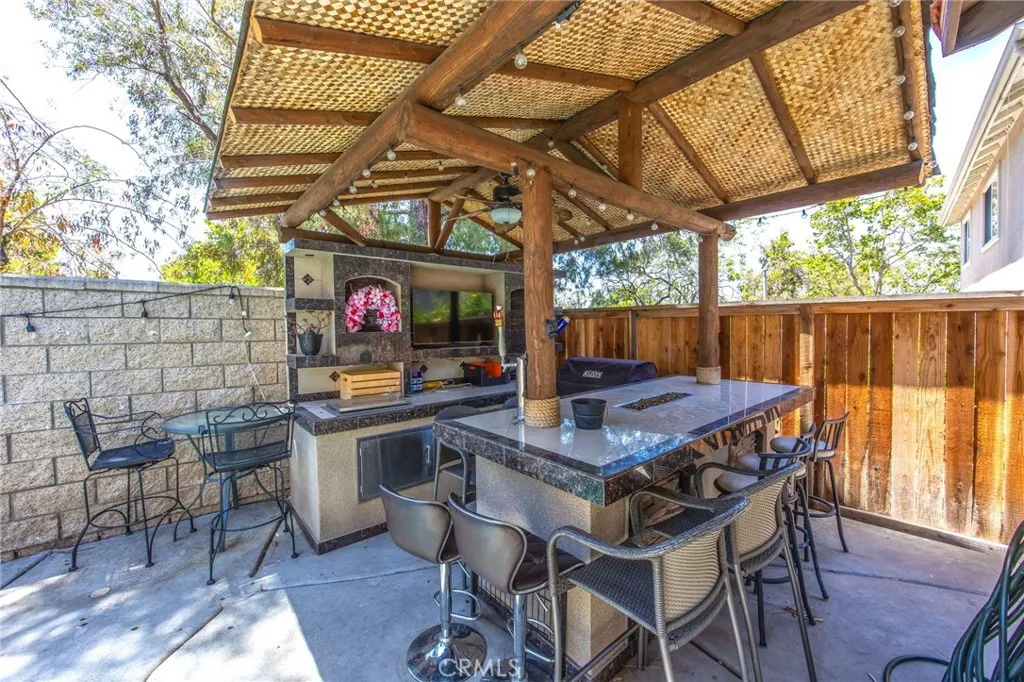 Covered backyard pavilion with bar seating and space for outdoor entertaining