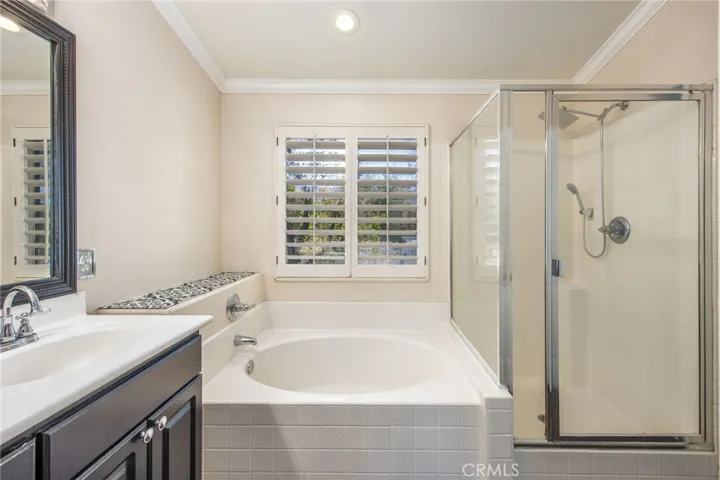 The spacious primary bath includes a separate shower and soaking tub