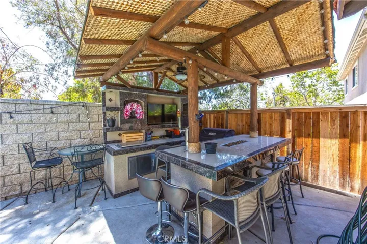 Covered backyard pavilion with bar seating and space for outdoor entertaining
