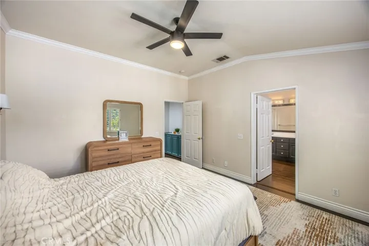 The primary bedroom offers a generous layout with direct access to the ensuite bath