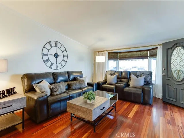Large, cozy living room with engineered hardwood floors
And bay window