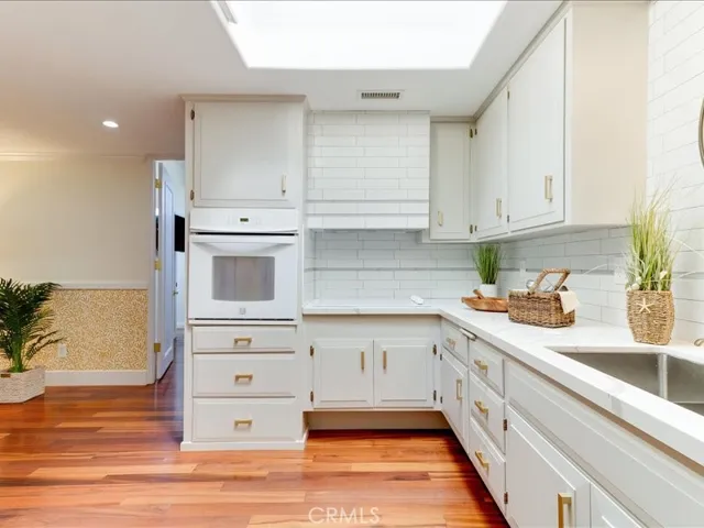 Custom backsplash and brass hardware