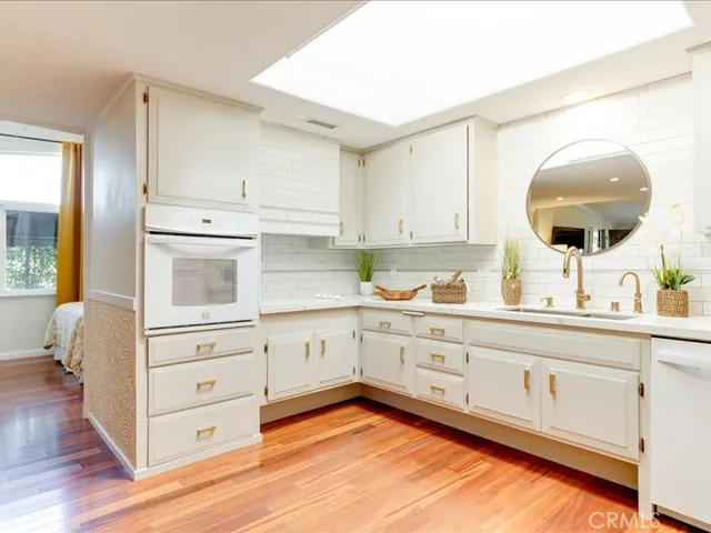 Notice the custom rangehood in the modern upgraded kitchen