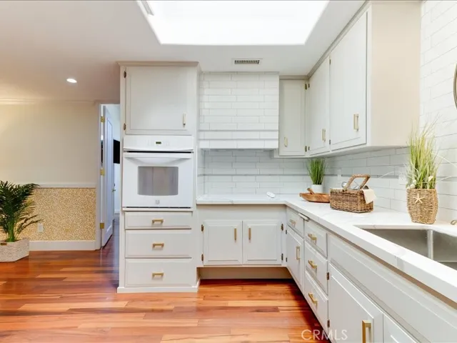 Custom backsplash and brass hardware