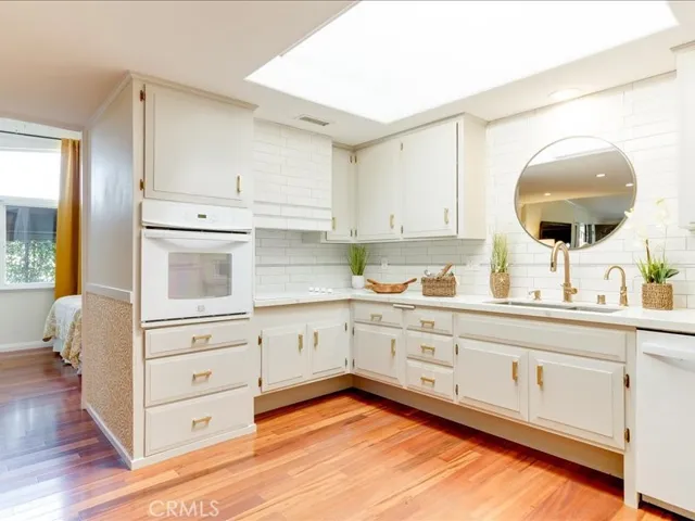 Notice the custom rangehood in the modern upgraded kitchen