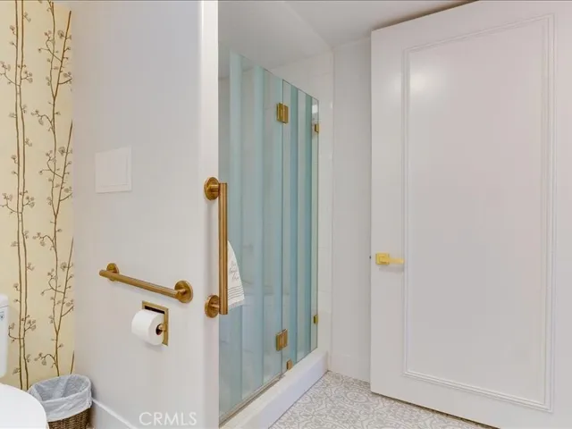 Main bathroom showing shower with custom glass enclosure