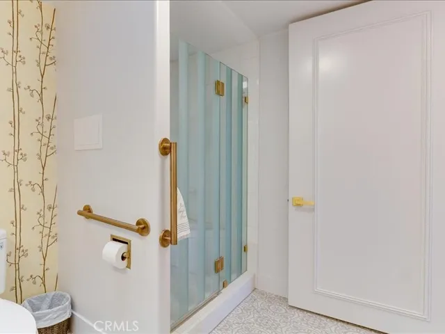 Main bathroom showing shower with custom glass enclosure