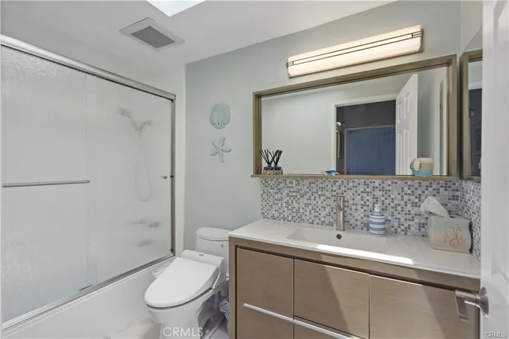 second bath with a tub shower and bidet toilet seat