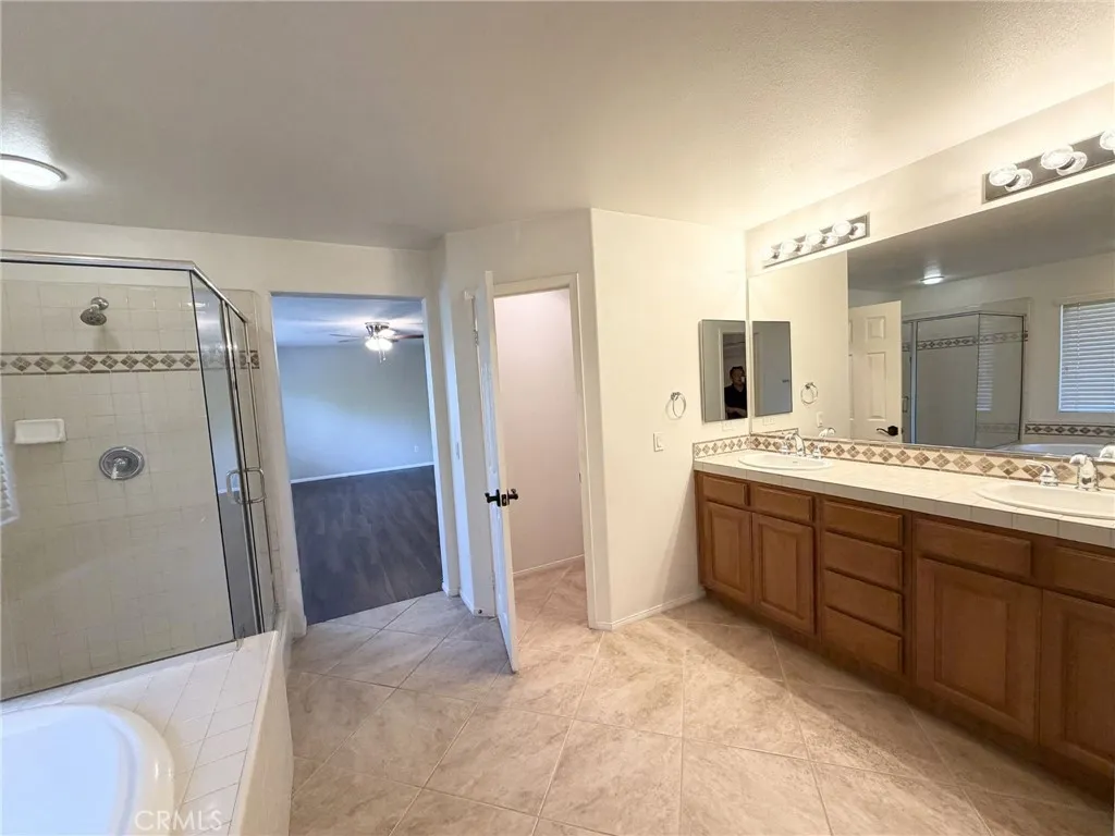 Spacious Primary Bathroom with Dual Vanities, Tub & Shower