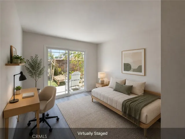 Virtually staged south-side bedroom with new flooring, natural light, and sliding door access to the backyard.
