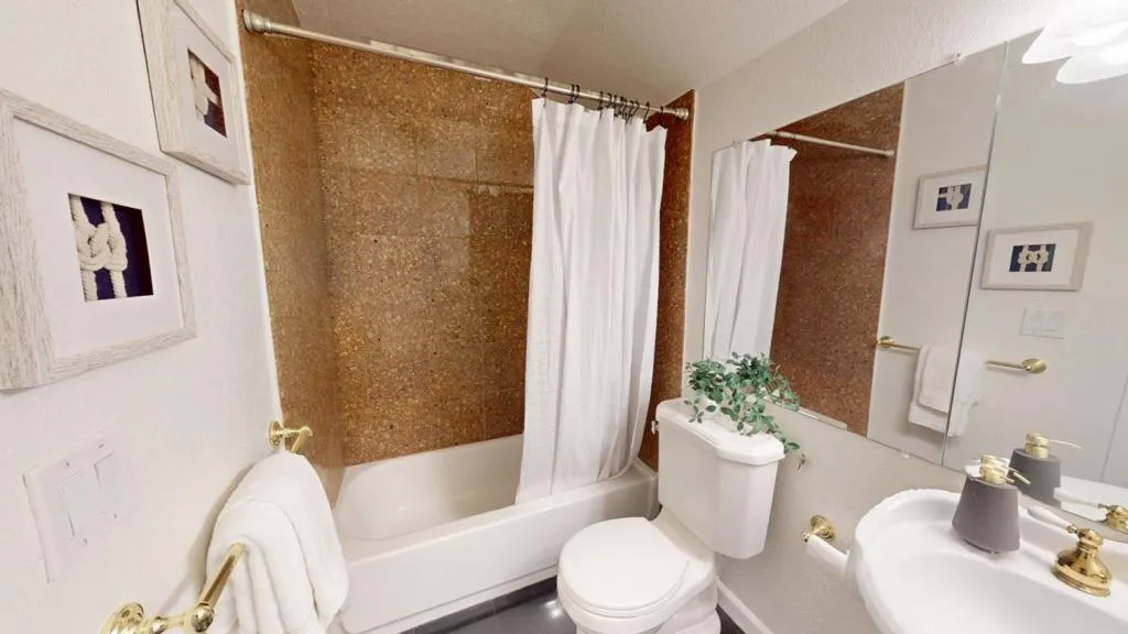 Junior primary bath has shower over tub.