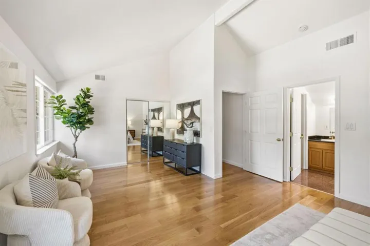 Primary beroom with its sitting area, private bath and walk-in closet