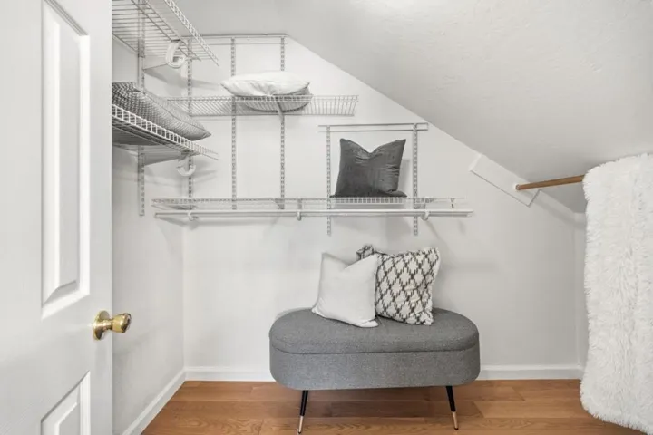 2nd floor primary bedroom walk-in closet, has a storage space under the ceiling.